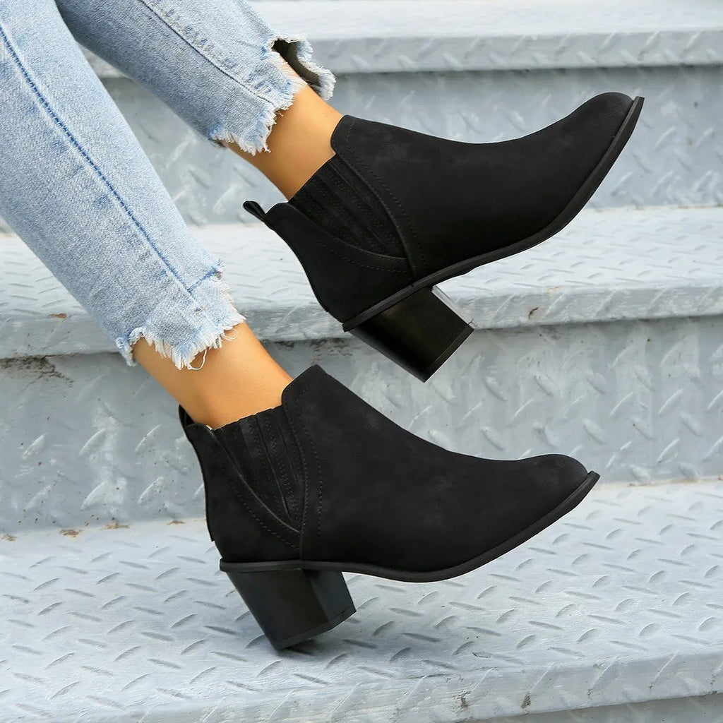 Women's black ankle boots with pointed toe and thick square heel, slip-on design