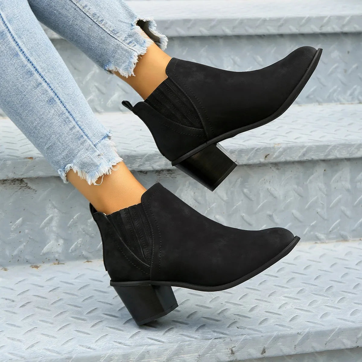 Women's black ankle boots with pointed toe and thick square heel, slip-on design