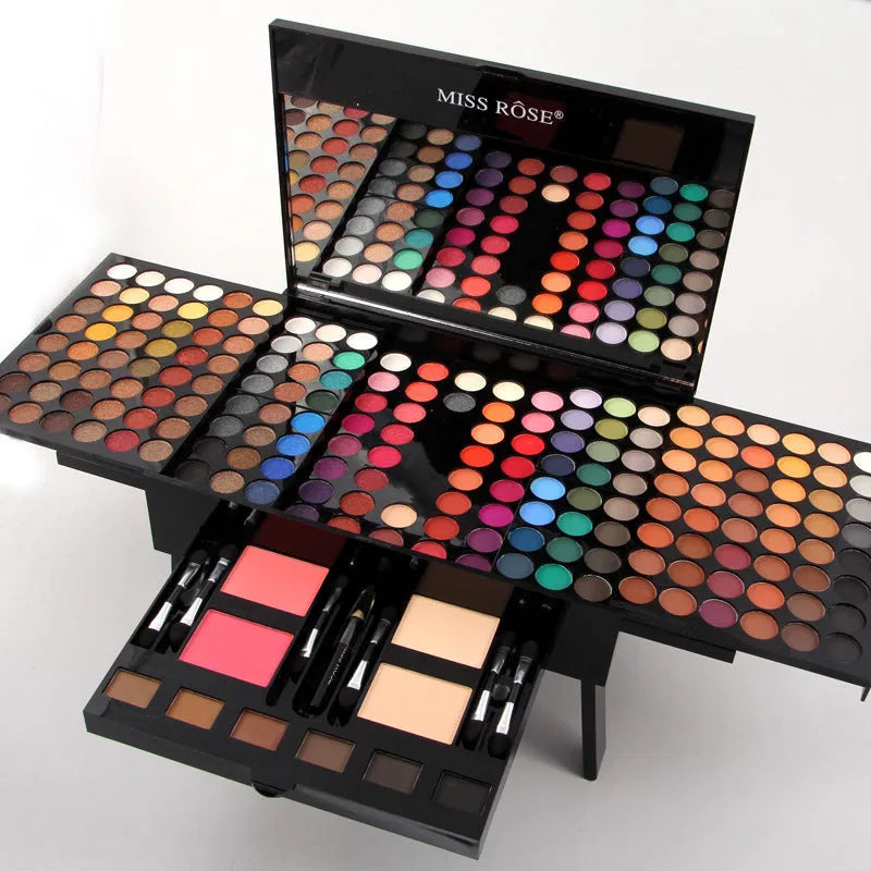 Open piano-shaped makeup palette showing rows of 190 coloured eyeshadow, blush, and powder pans