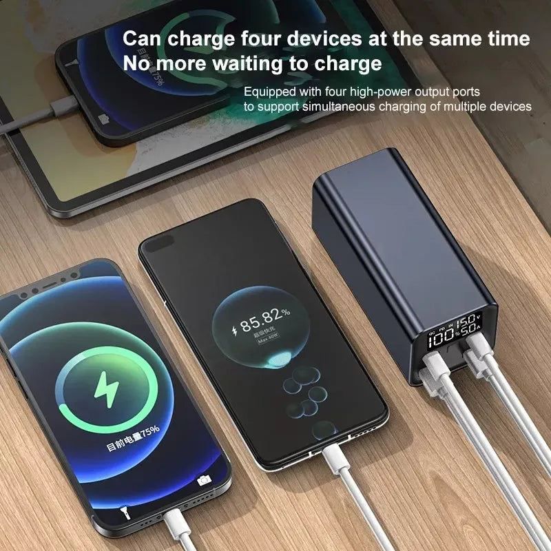 65W metal laptop power bank in black, blue, or grey colours showing size next to a laptop.