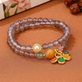 Close-up of a natural grey agate two-circle bracelet with retro design on a wrist.
