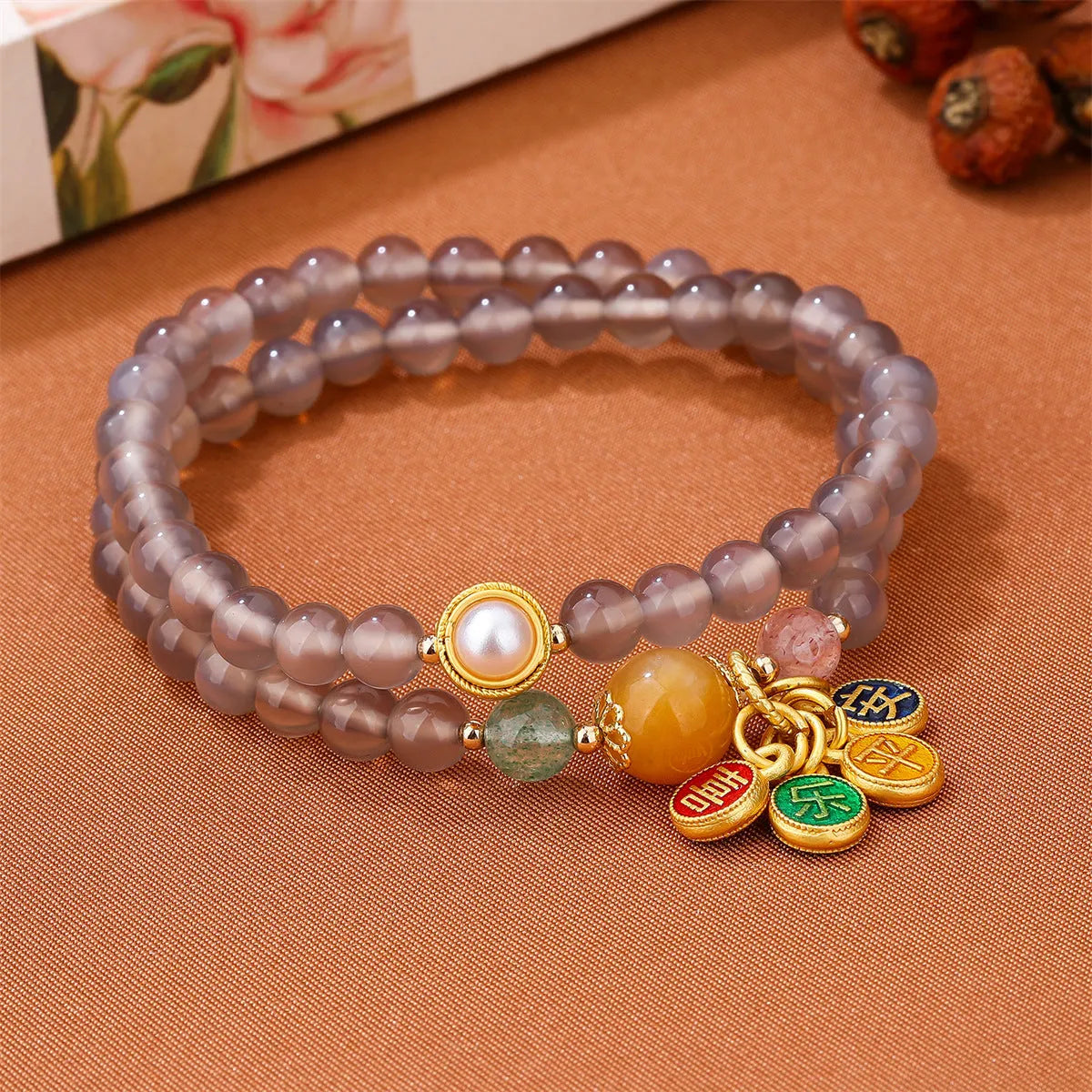 Close-up of a natural grey agate two-circle bracelet with retro design on a wrist.