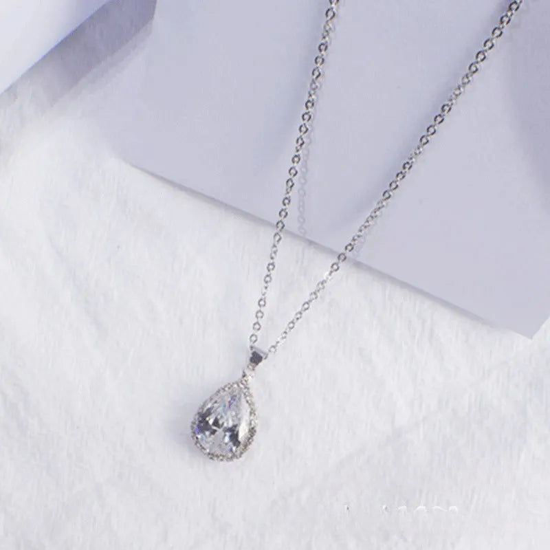 Women's pink alloy water drop necklace with geometric design and rose gold rhinestones on model