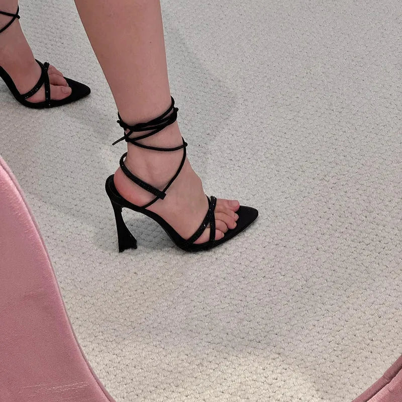 Black satin women's high heel sandals with adjustable ankle straps and a block heel.