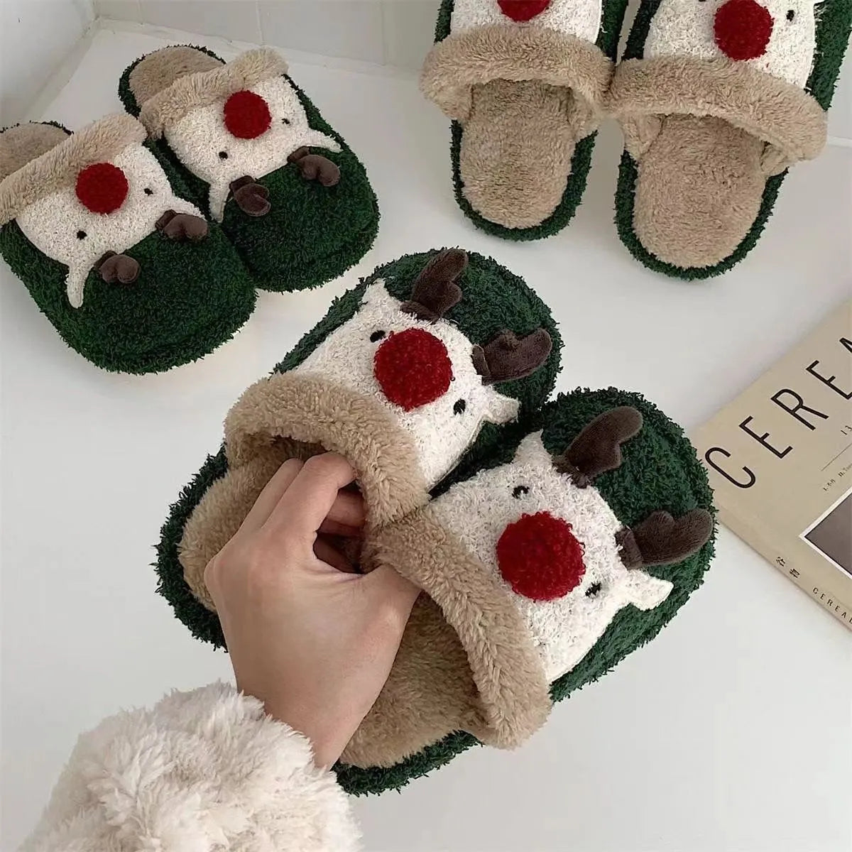 Women's Christmas elk plush slippers with decorative antlers and non-slip PVC soles in brown, green, and pink colours