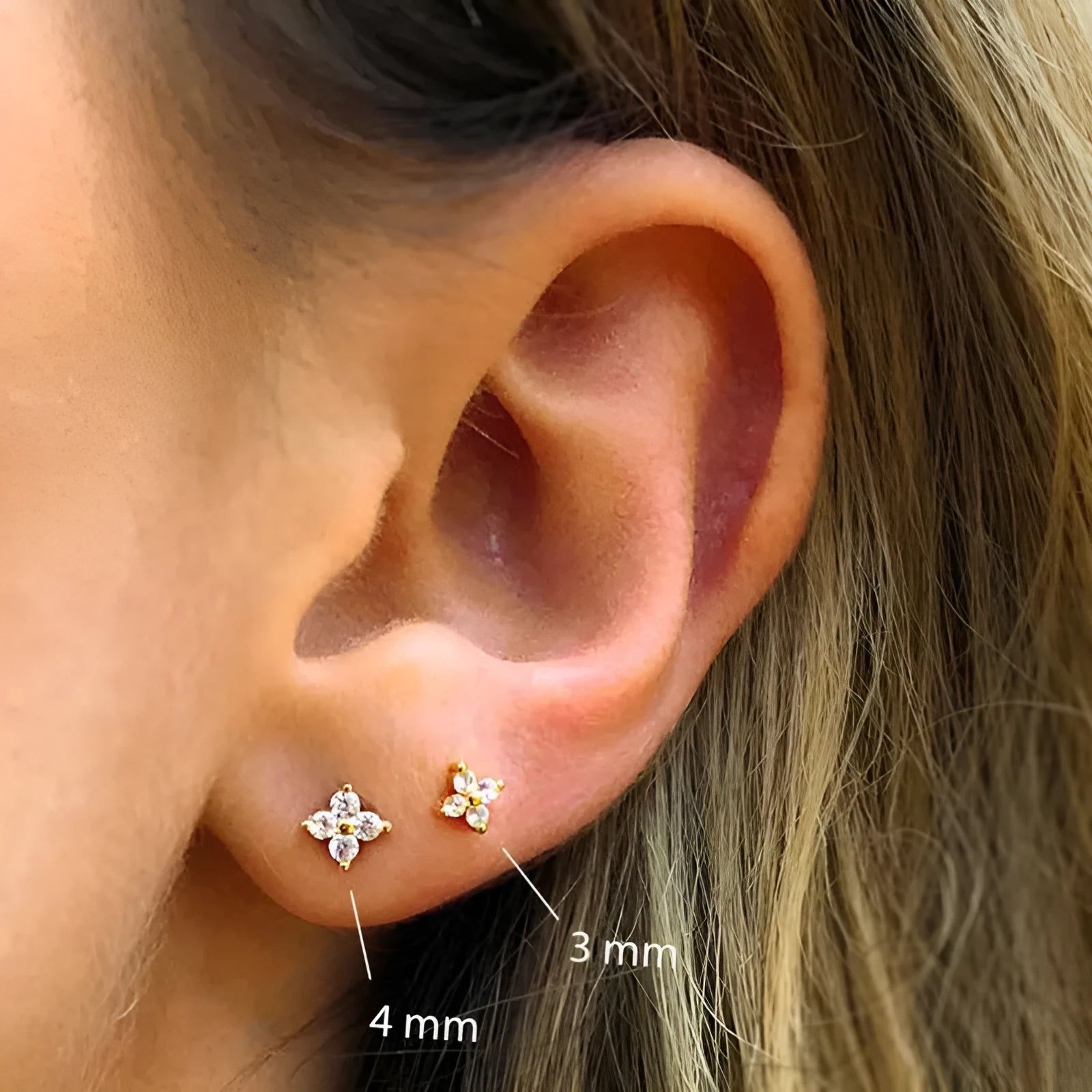 S925 sterling silver stud earrings with a geometric flower and crystal design in gold or platinum finish.