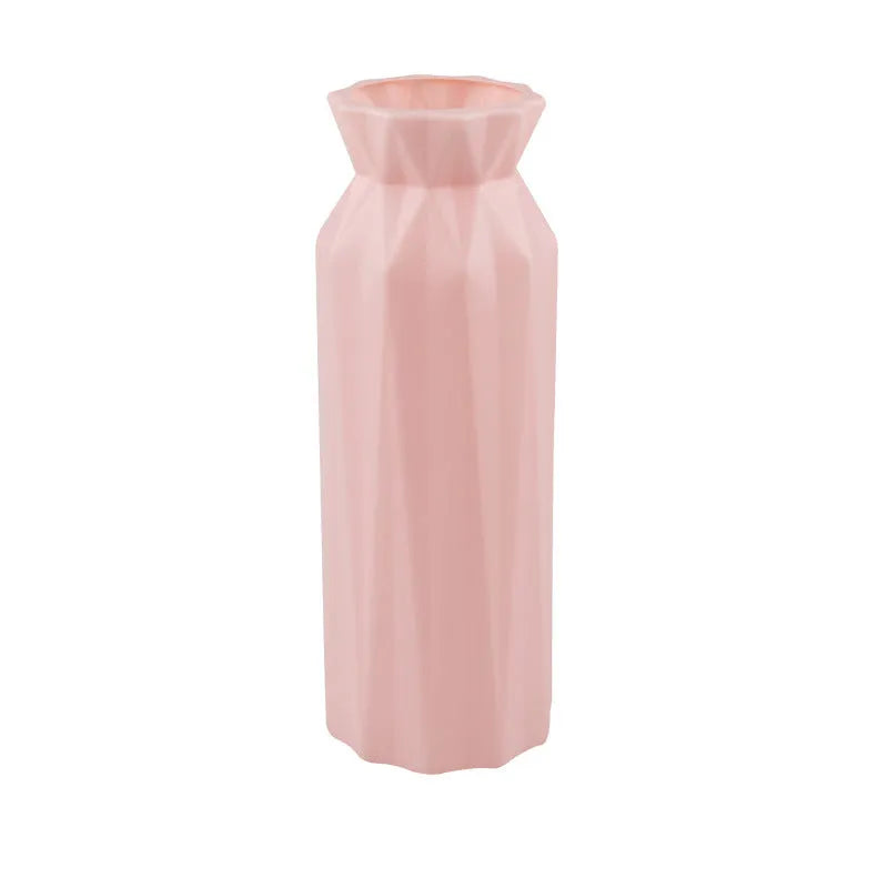 Simple green melamine plastic vase with a 7.2cm base diameter on a wooden table.