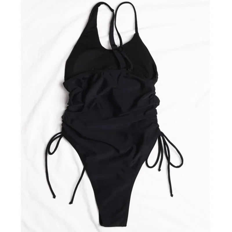 Black tight-fitting women's dress with sloping shoulders and decorative lacing detail, sleeveless design.