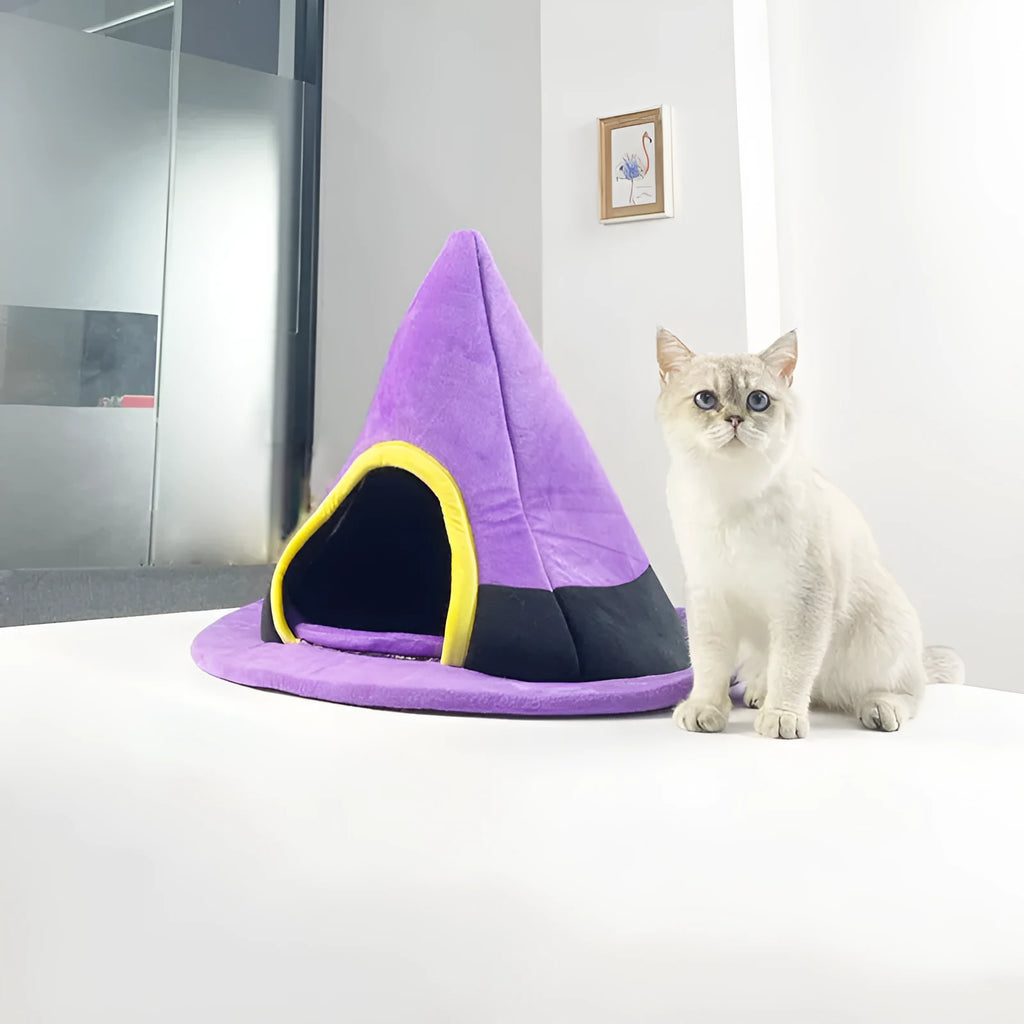 Purple cloth witch hat shaped cat bed for Halloween.