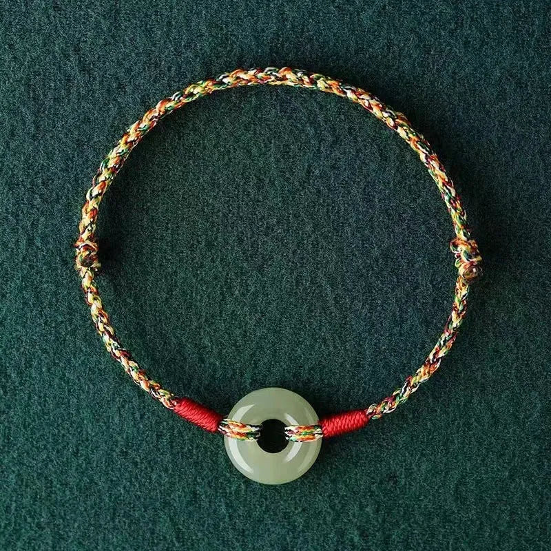 Colourful woven rope bracelet with silver peace buckle clasp on wrist