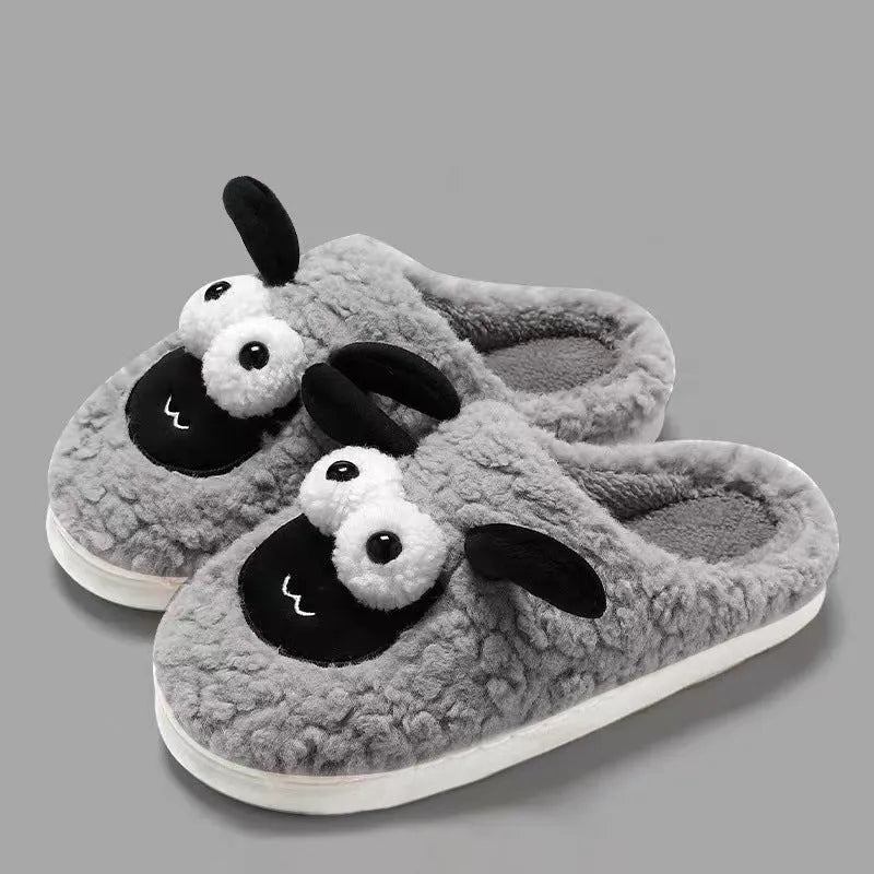 Brown unisex slip-on slippers with suede upper and light sole on a wooden floor.
