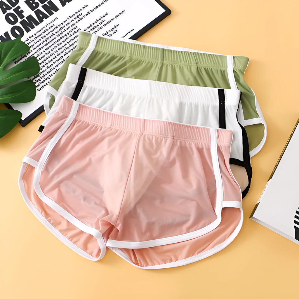 Men's black ice silk low waist sports boxers with mesh detail on a plain background.
