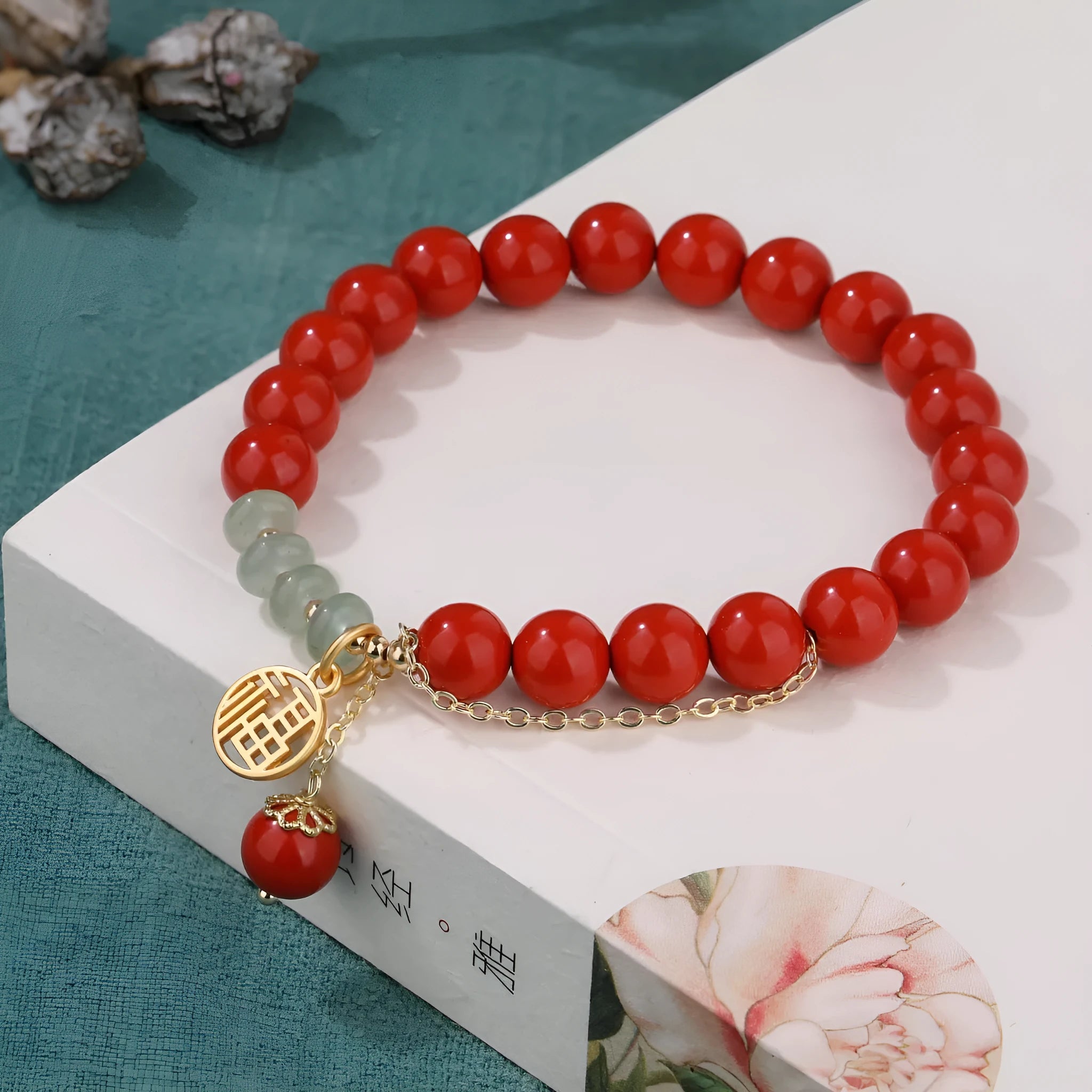 Retro red cinnabar bracelet with carved fu character, jade bead, and leather tassel cord