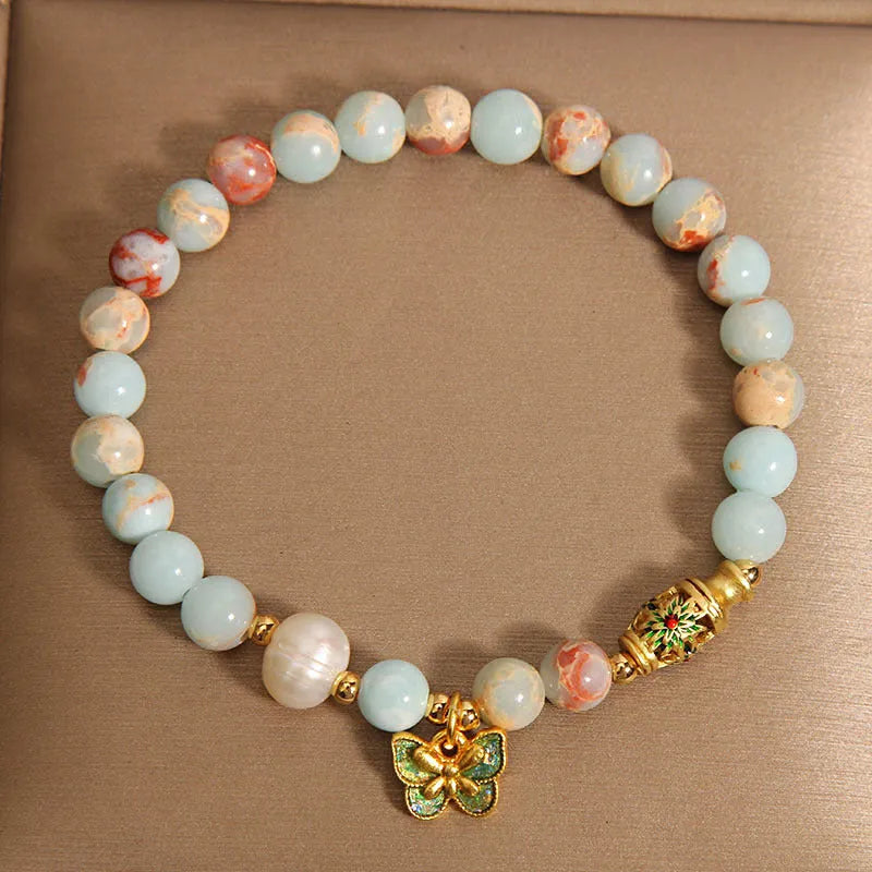 Blue women's bracelet with butterfly pendant containing Shoushan stone and freshwater pearls.