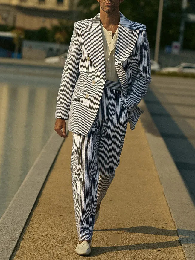 Blue and white striped women's blazer and trouser suit set on a hanger