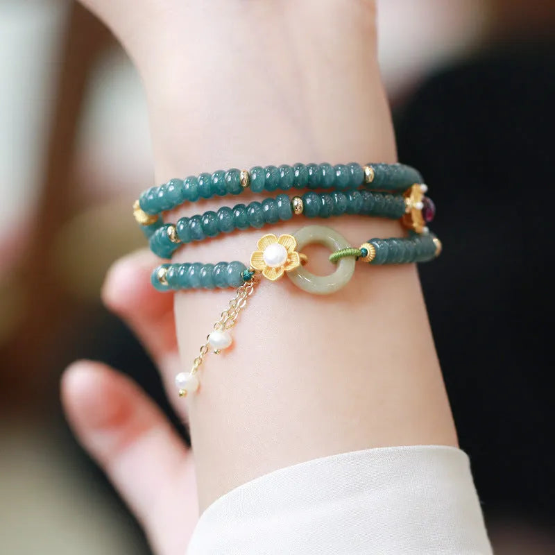 Blue water jade abacus bead and tourmaline bracelet on three sterling silver rings for women.