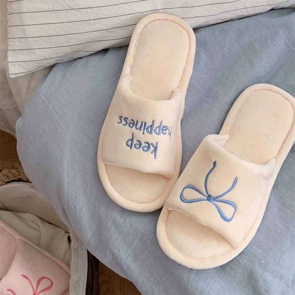 Ladies cotton slippers with suede upper, artificial wool lining, flat non-slip PVC sole, bow and letter detail, beige yellow pink black