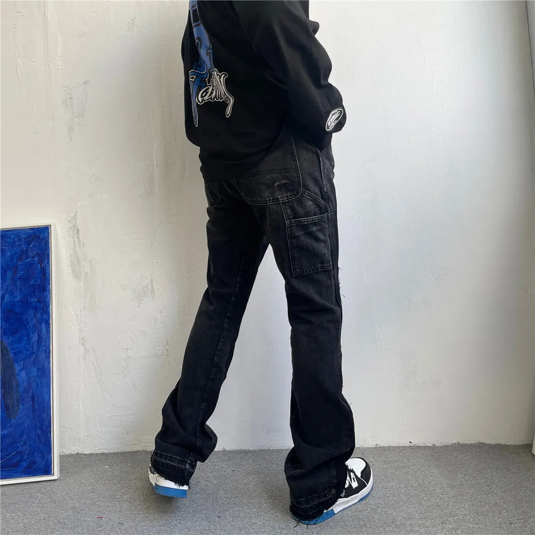Women's micro flared patchwork raw edge jeans in black denim with loose straight tube fit, front view