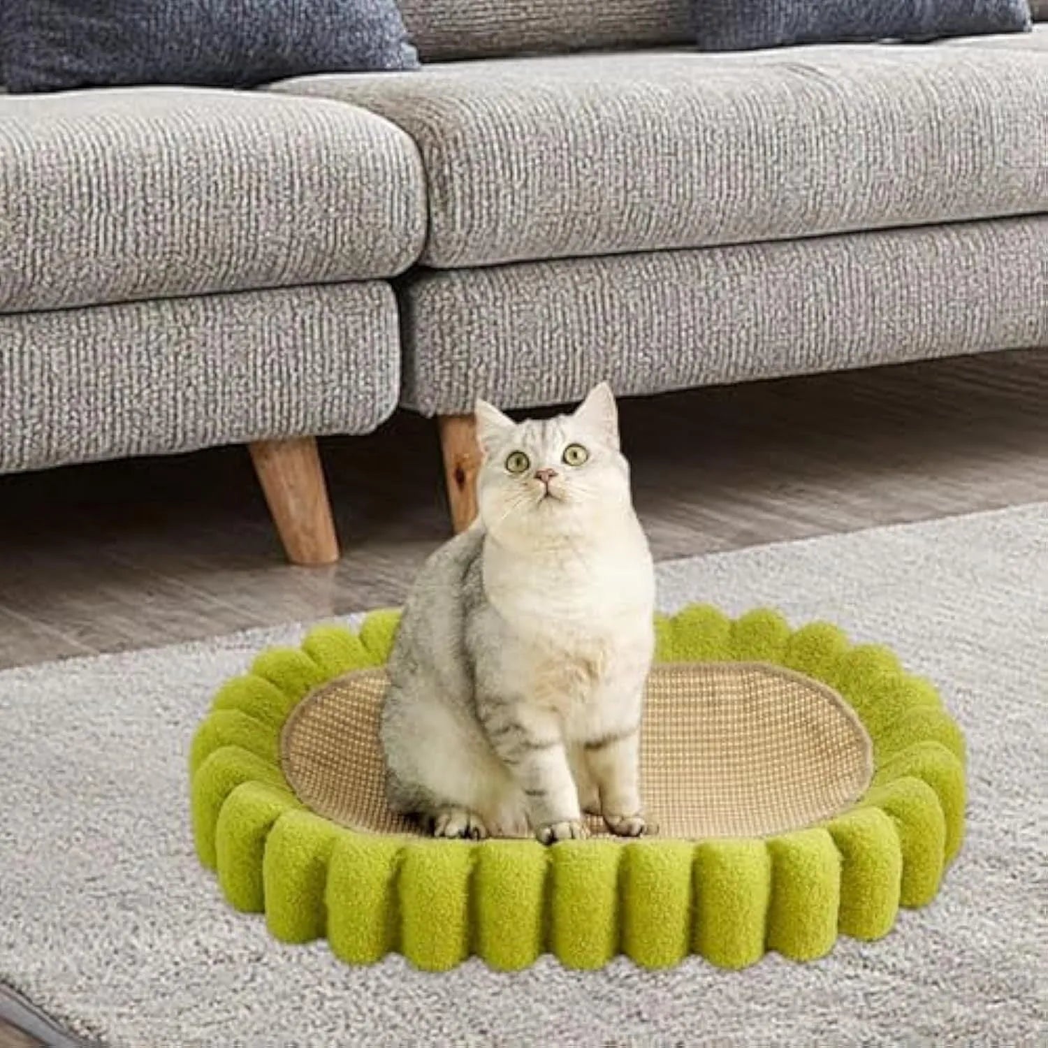 Green oval cat scratcher pad with sisal surface serving as scratching area and cat bed