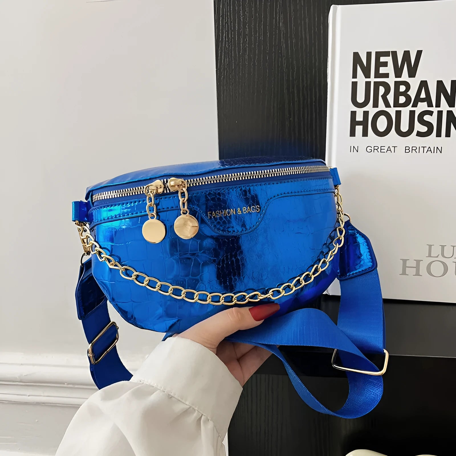 Shiny chest bag with WesternWide shoulder strap, chain detail, and hard PU shell in black colour