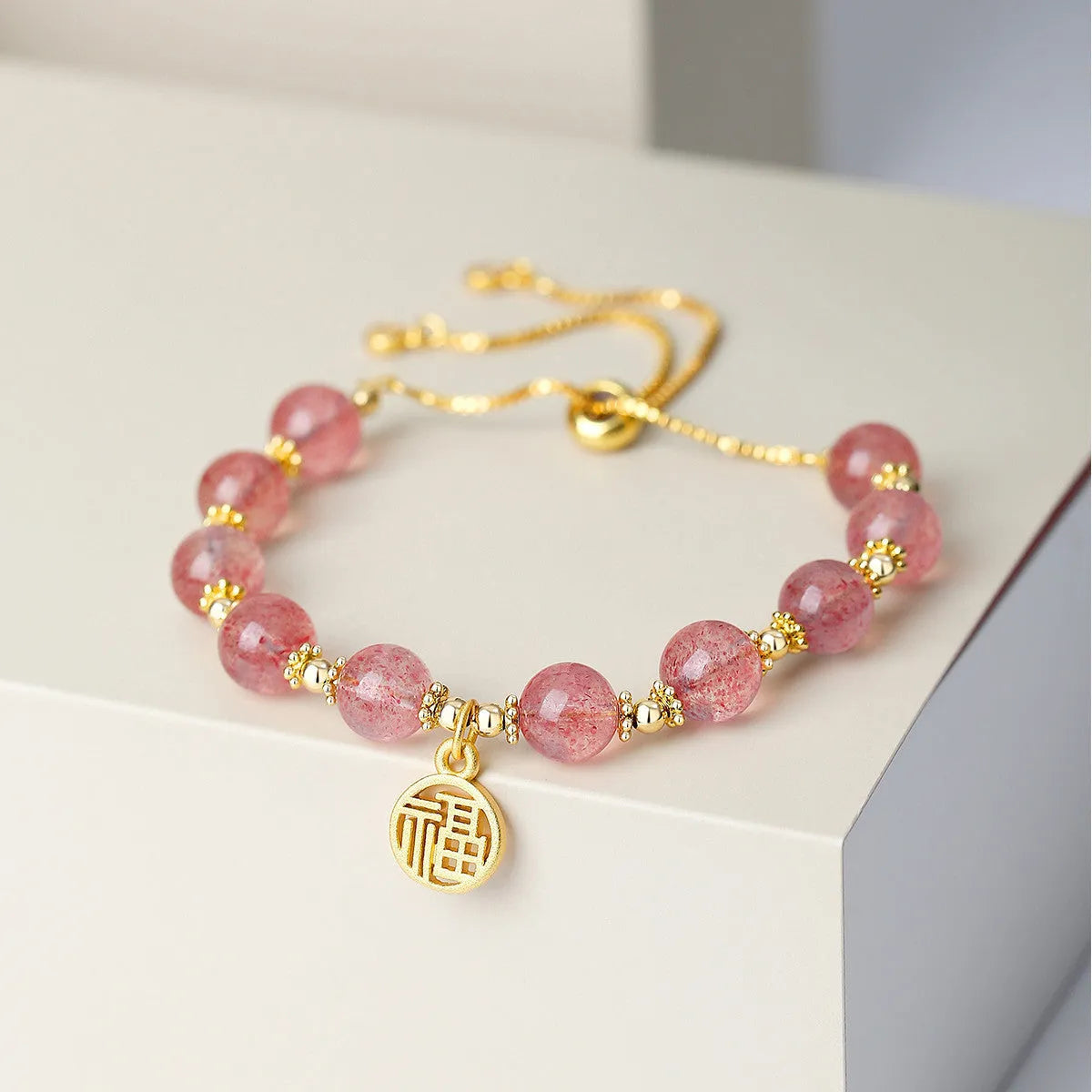 Women's Strawberry Quartz crystal bracelet with geometric design and Fu character, electroplated metallic finish