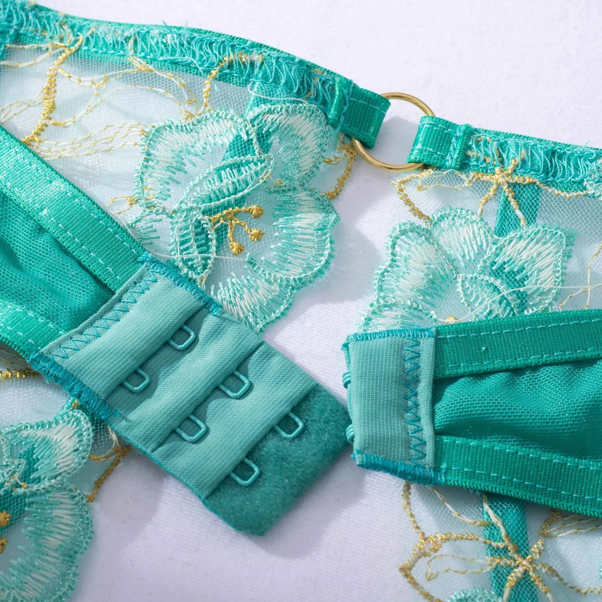 Light green embroidered women's bra and bikini set in three-point style.