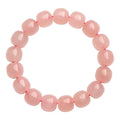 Natural pink crystal barrel bead bracelet with geometric design on wrist