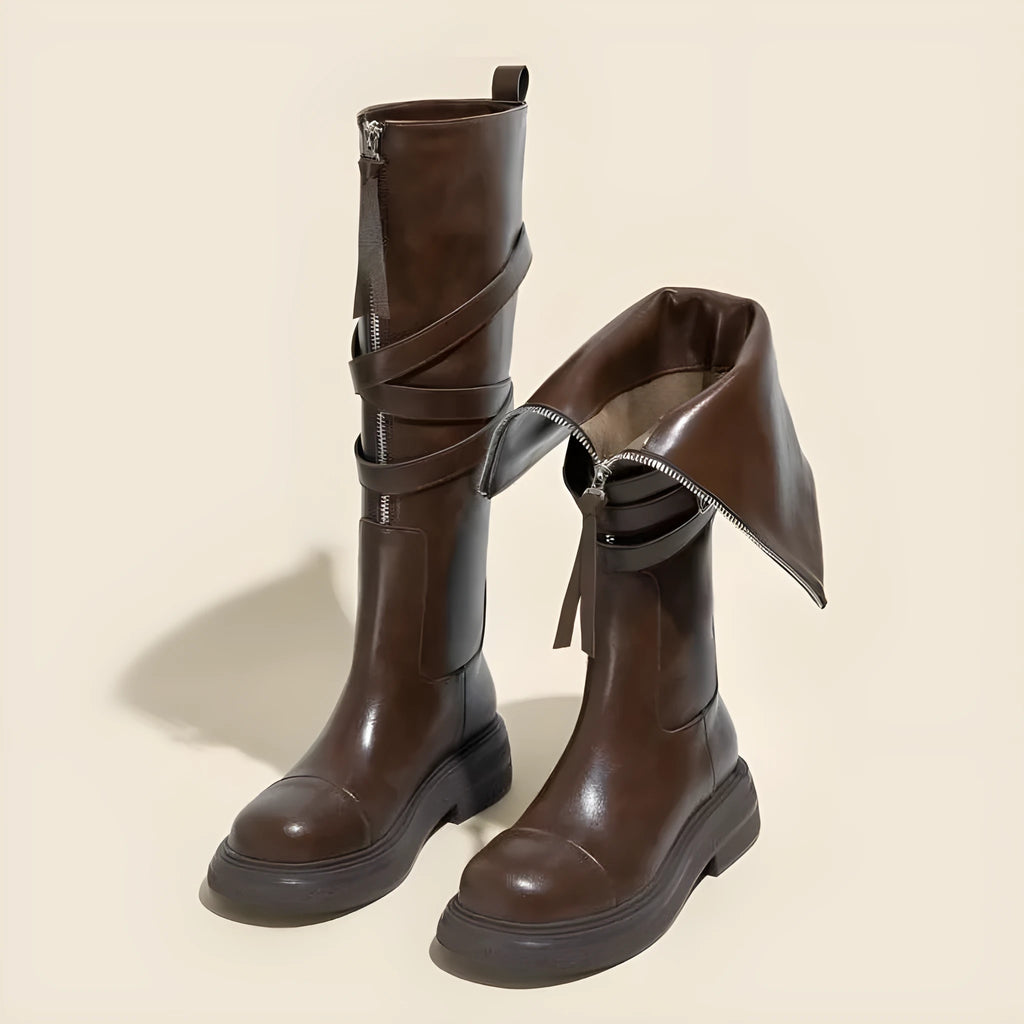 Brown women's riding boots with thin high tube, front zipper, round toe, and chunky heel