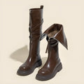 Brown women's riding boots with thin high tube, front zipper, round toe, and chunky heel