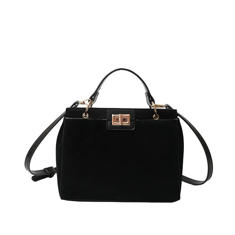 Retro western style messenger bag in black stone pattern with shoulder strap and square vertical shape