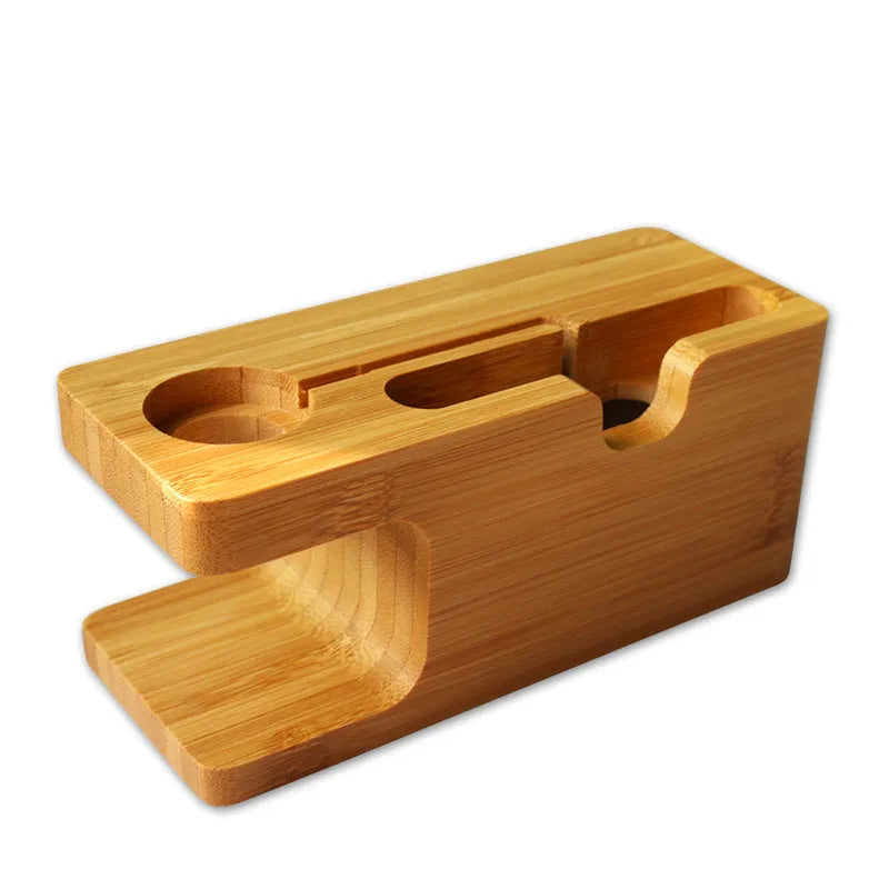 Natural bamboo smartphone stand with carved ornament detail on an office desk.