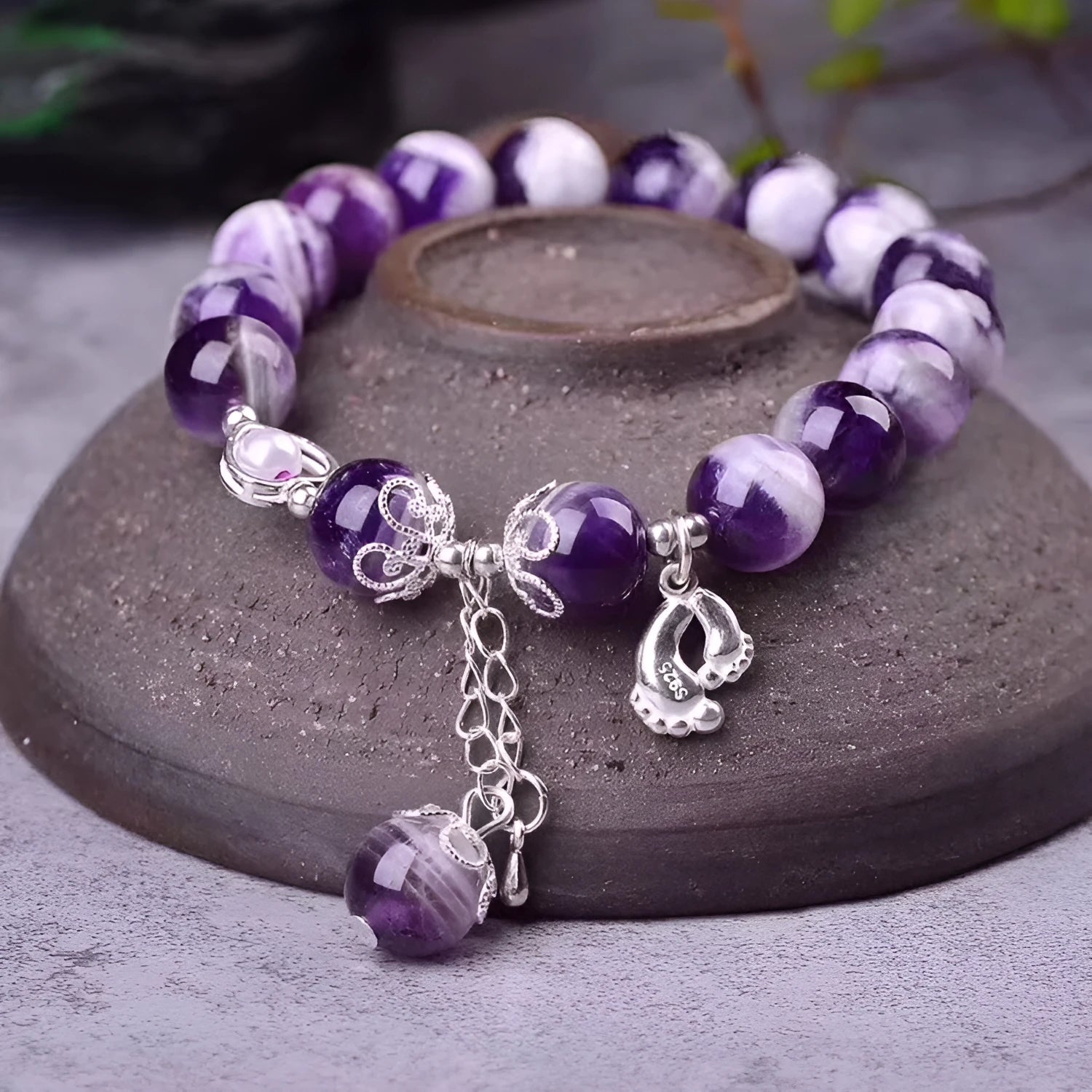 Natural amethyst bracelet with 10mm round beads on a woman's wrist.