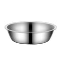 Stainless steel pet food bowl with non-slip base on a kitchen floor
