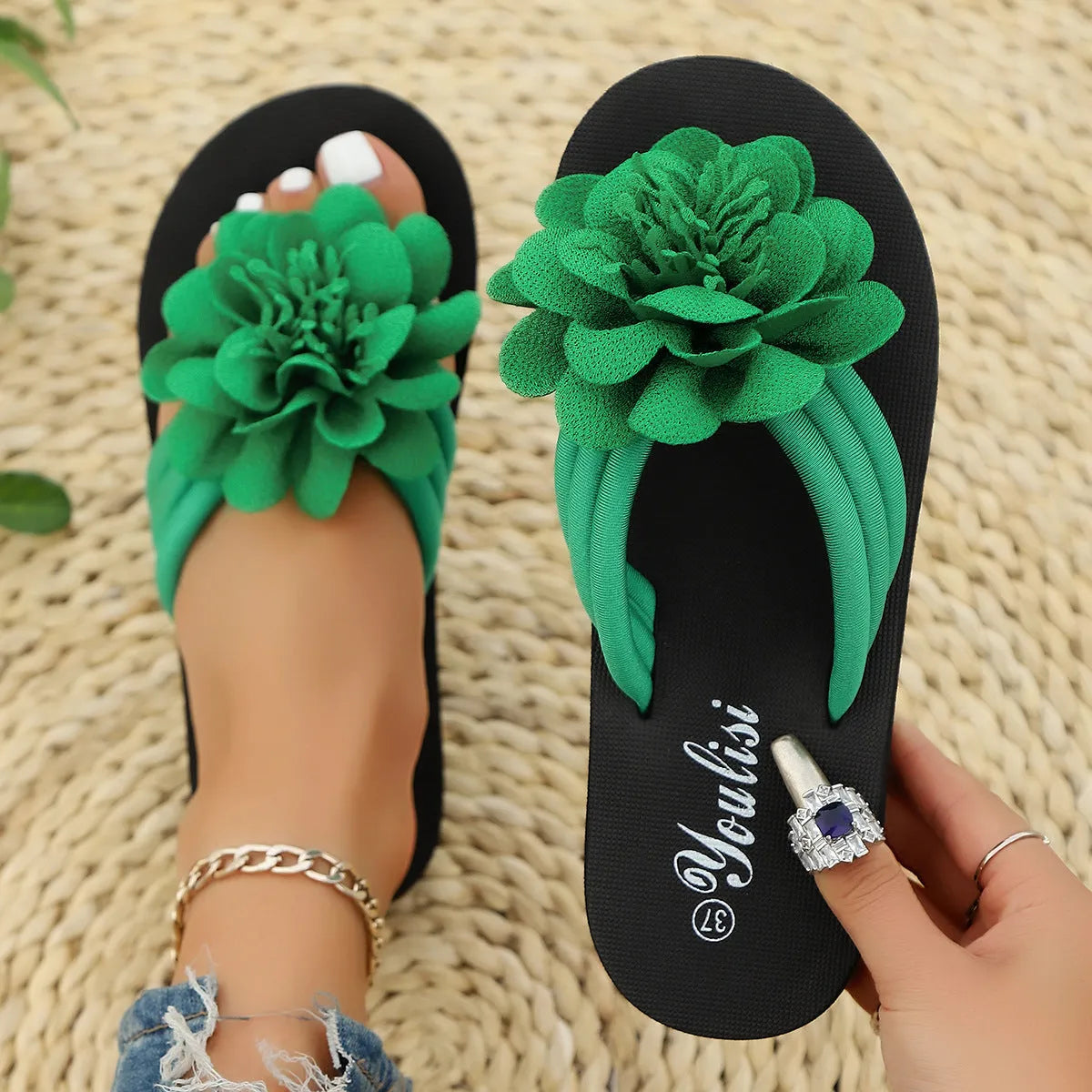 Solid colour flower flip-flops with a floral detail on a viscose upper and a lightweight EVA sole.