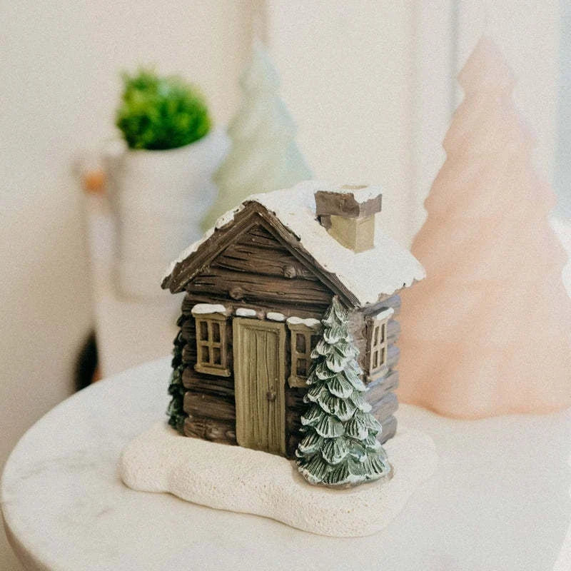 Rustic log cabin-shaped incense burner with wood-inspired finish, creating a cozy and inviting atmosphere in the home