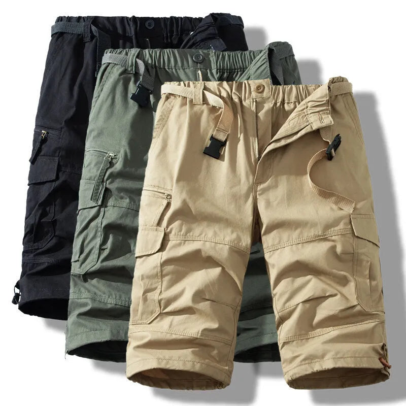 Man wearing thin cotton cropped overalls in army green, showing the relaxed summer fit.