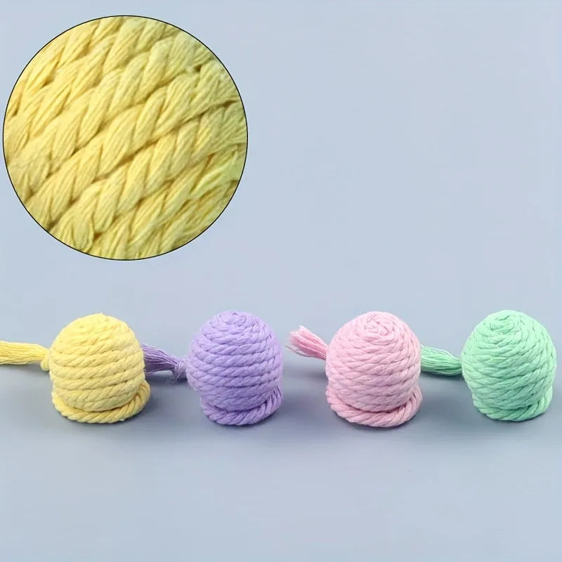 Colourful cat toy ball with attached rope and internal bell for kitten play