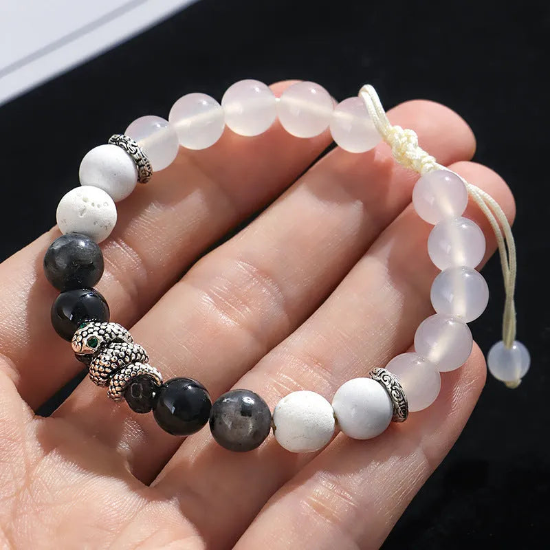 A matching couple bracelet set: one black agate and one white agate bracelet with snake chain clasps.