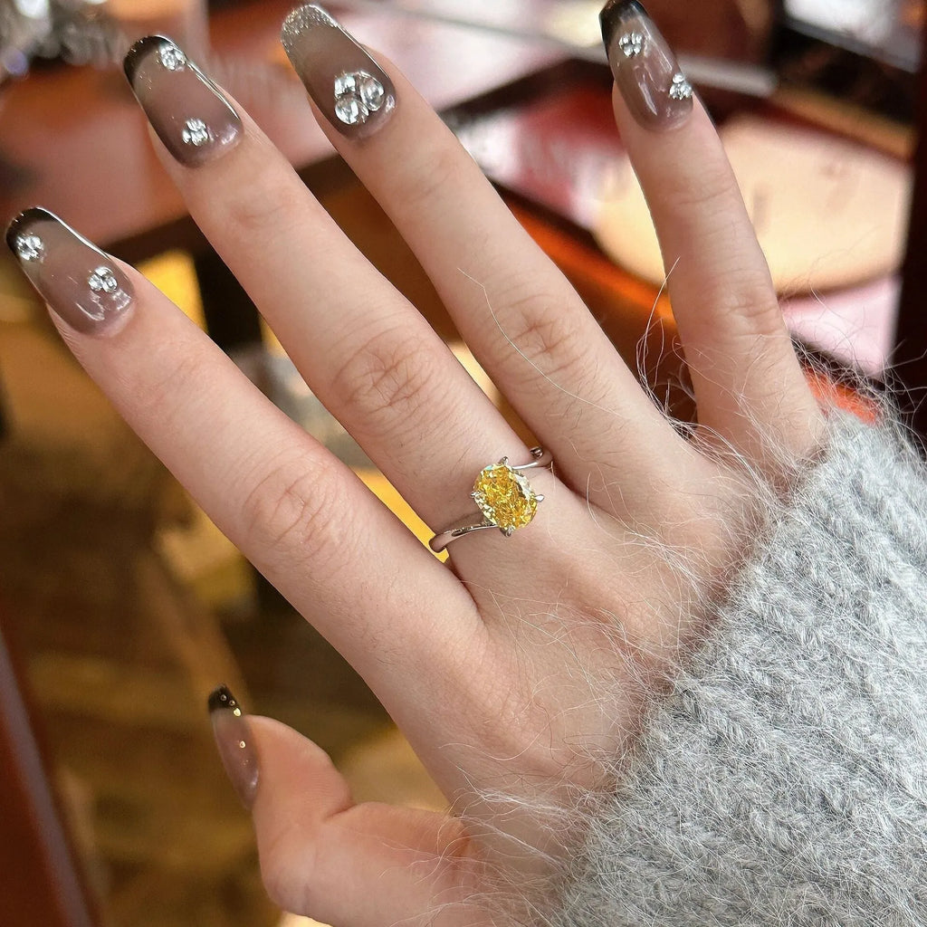 Women's copper ring with a bright yellow crystal sugar finish on a finger.