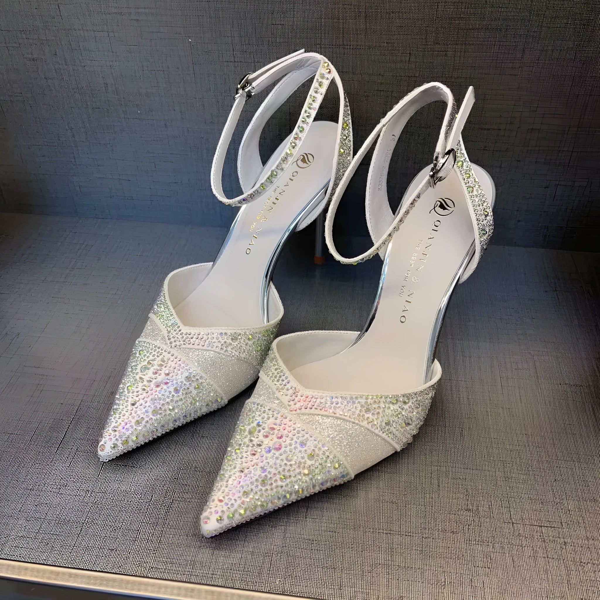 Women's hollow high heels with red sole, stiletto heel and pointed toe in black colour