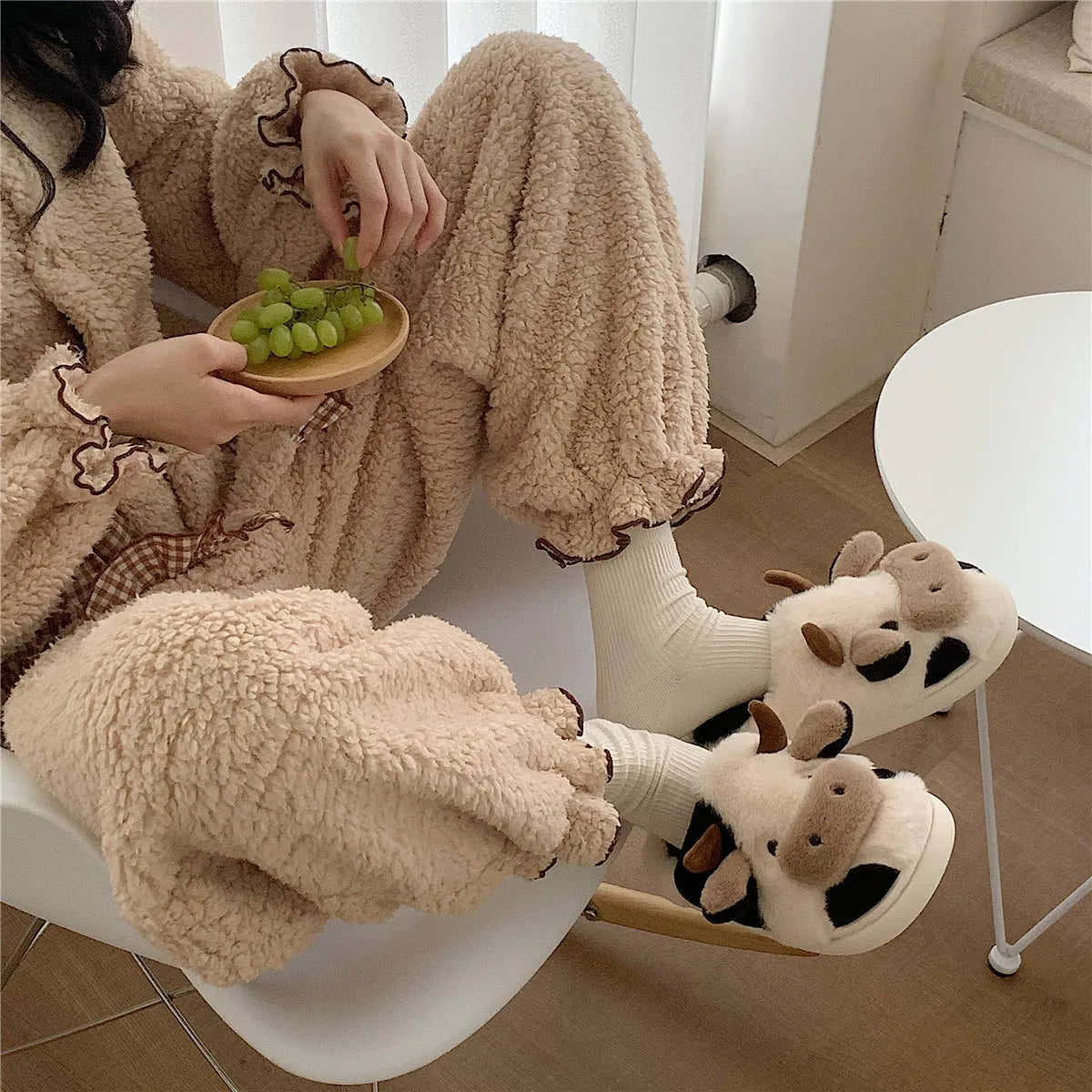 White and coffee cartoon cow slippers for women with plush faux fur and a textured non-slip sole.