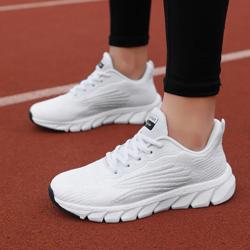 Low-top black and white running sneakers with cross strap design and MD sole