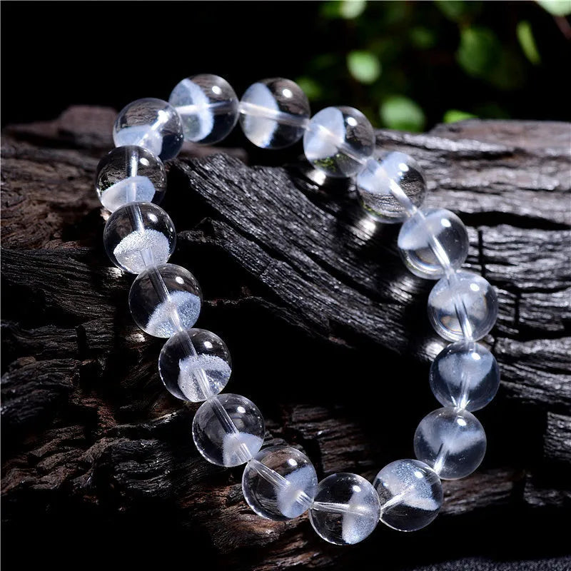 Women's natural white ghost bracelet with a white crystal pyramid charm and ruyi design elements.