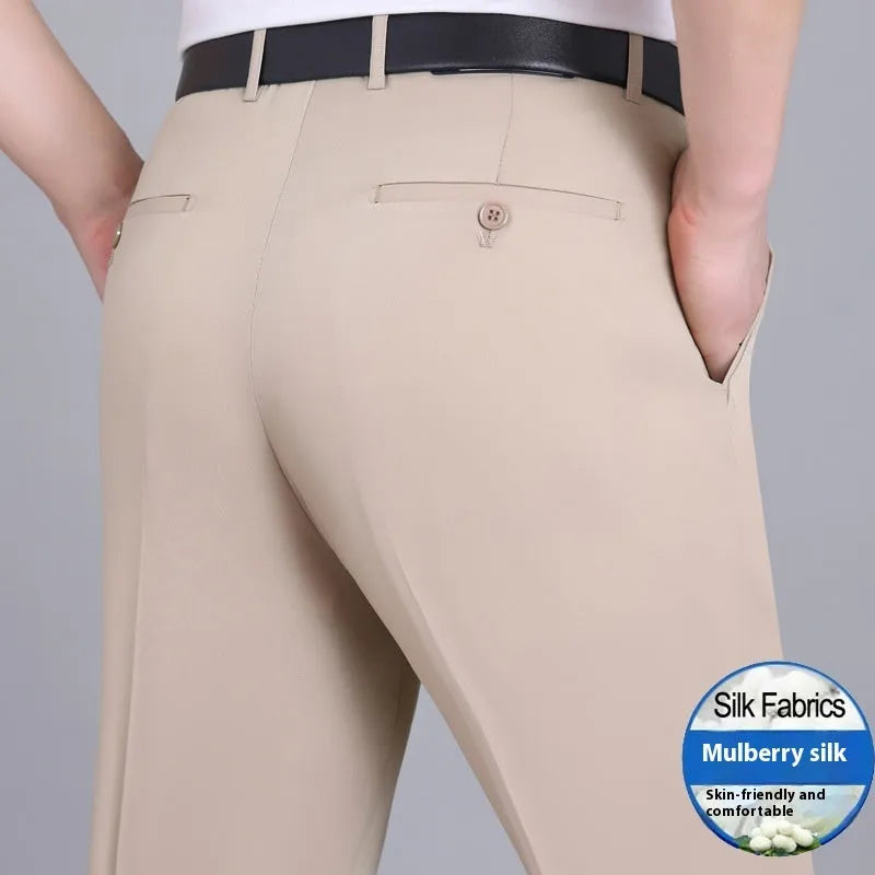 Man wearing dark blue straight-cut high-waist business trousers made from a mulberry silk blend.