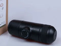 Black portable manual espresso coffee machine with stainless steel parts, shown at 17.5cm height.