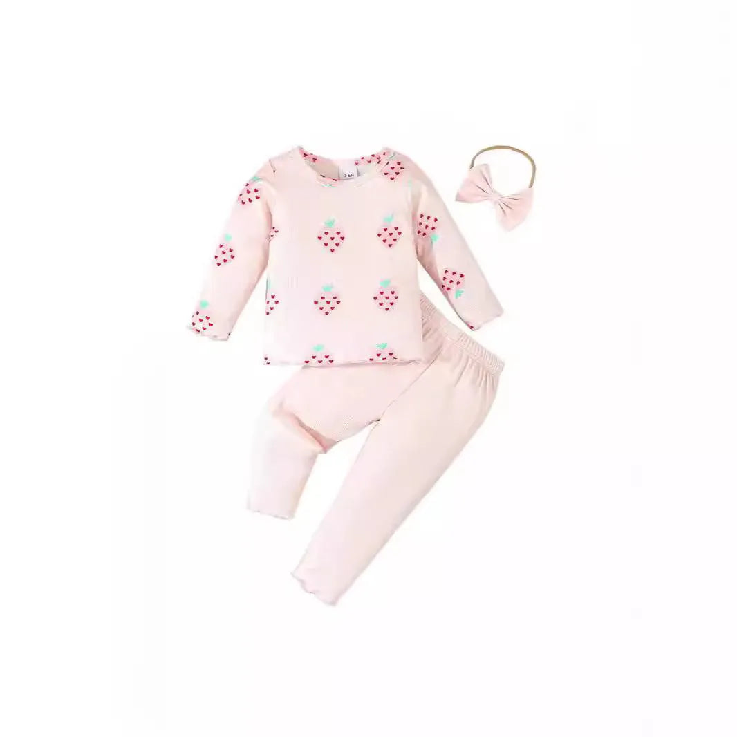 Infant wearing a printed long-sleeve top, solid trousers, and matching cap from the 3-piece suit set.