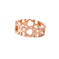 Gold titanium steel hollowed cut letter ring with geometric design on white background