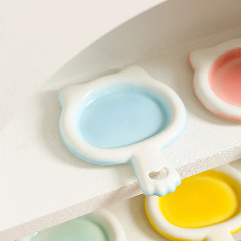 Ceramic cat bowl in blue, green, pink, or yellow colour with a shallow mouth design for pet food and water.