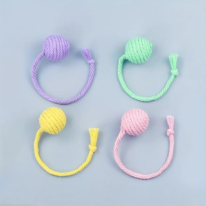 Colourful cat toy ball with attached rope and internal bell for kitten play