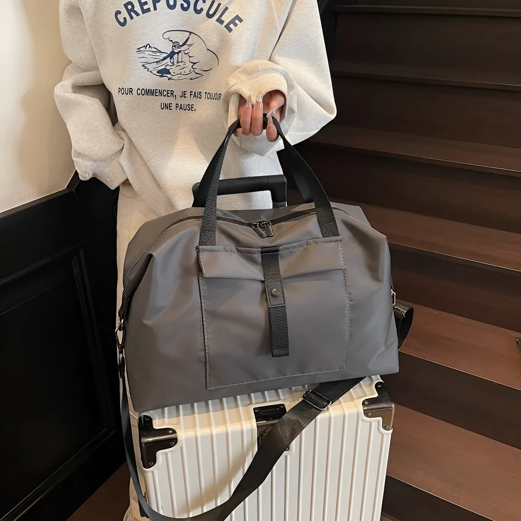 Grey one-shoulder Oxford cloth travel bag with 36-55L capacity and breathable lining